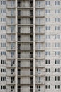 Textured pattern of a russian whitestone residential house building wall with many windows and balcony under construction Royalty Free Stock Photo