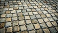 A textured pattern of square stone pavement blocks set in a grid, featuring variations in color and size, creating a visually Royalty Free Stock Photo