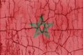 Textured photo of the flag of Morocco with cracks.