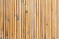 Textured photo of a vertical thin brown bamboo wall Royalty Free Stock Photo
