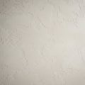 A textured plaster wall with a rough, uneven surface. The color is a neutral off-white, Royalty Free Stock Photo