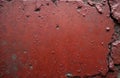 Textured red concrete wall surface with chips, scratches, cracks. Aged, worn material rough, grimy stone texture with retro, Royalty Free Stock Photo