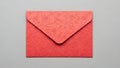 A textured red envelope resting on a plain surface Royalty Free Stock Photo