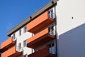 textured red stucco balconies. steel picket side railing. perspective view. residential building exterior elevation