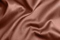 Textured rose gold fabric as background, closeup