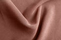 Textured rose gold fabric as background, closeup