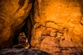 Textured sandstone canyon near Arches National Park with small cairn lit from narrow band of light Royalty Free Stock Photo