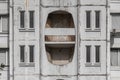 Textured shabby concrete wall with decorative windows of multi storey residential house