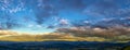 Textured sky at sunset over landscape valley, panorama