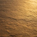 A textured stone surface is illuminated by warm, golden lighting, creating a Royalty Free Stock Photo