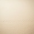 A textured stone surface is visible, featuring a uniform beige tone. The texture is slightl Royalty Free Stock Photo
