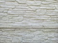 Textured stone wall background featuring white stone bricks arranged in a pattern. Ideal for design projects, interior d Royalty Free Stock Photo