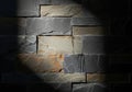 Textured stone wall with dramatic spotlight illumination Royalty Free Stock Photo