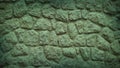 Textured stone wall with a natural gradient of green and teal hues, perfect for 4K backgrounds, wallpapers, and banners Royalty Free Stock Photo