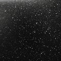 A textured surface with a black background speckled with irregularly spaced white dots and granules Royalty Free Stock Photo