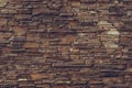 Textured surface of a brown dirty stone wall. Old red brick wall background. Concrete bricks wall pattern. Grunge granite texture. Royalty Free Stock Photo