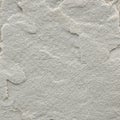 A textured surface featuring light gray sandstone with rough, uneven layers. The stone exhibits a Royalty Free Stock Photo