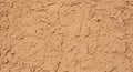 A textured surface with a natural, earthy appearance. It consists of irregular, uneven patterns and Royalty Free Stock Photo