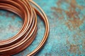 A textured surface provides the backdrop for a copper ring with multiple bands, which is captured in warm and inviting Royalty Free Stock Photo