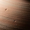 Of a textured surface with a reddish-brown hue, resembling sand or Royalty Free Stock Photo