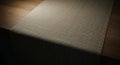 A textured table runner made of coarse woven fabric covers a wooden table. The Royalty Free Stock Photo