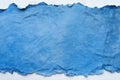 Textured torn blue paper background for creative designs and crafts Royalty Free Stock Photo