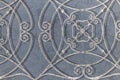 Ornate wrought iron pattern on blue wallcovering background Royalty Free Stock Photo