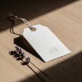 A textured white paper tag with a rounded hole and attached string lies on a wooden Royalty Free Stock Photo