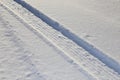 Snow tires imprinted on the road- white texture of real snow for winter back grounds Royalty Free Stock Photo