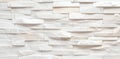 Textured white stone wall with layered panels, perfect for modern interior design and architectural projects Royalty Free Stock Photo