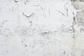 A textured white wall with extensive peeling and flaking paint. Royalty Free Stock Photo