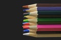 Textured wood colored pencils. Colored pencils macro. Assortment of colored wood drawing pencils on black background Royalty Free Stock Photo