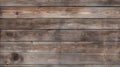 A textured wooden fence with aged, weathered boards