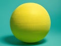 A textured yellow sphere on a teal background Royalty Free Stock Photo