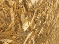 Textures from an angle of wooden yellow building material from shavings and compressed sawdust OSB, furniture production waste. Royalty Free Stock Photo