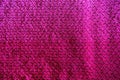 Textures of this close-up of a pink crocheted blanket.