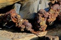 Textures and shapes in rocks with a rusted chain