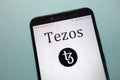 Tezos XTZ cryptocurrency logo displayed on smartphone