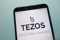 Tezos XTZ cryptocurrency logo displayed on smartphone