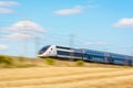 A TGV Duplex high-speed train in the french countryside with motion blur Royalty Free Stock Photo
