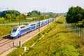 A TGV high speed train driving in the french countryside Royalty Free Stock Photo