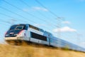 A TGV high-speed train in the french countryside with motion blur Royalty Free Stock Photo