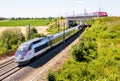 A TGV Inoui and a Thalys high speed trains pass each other Royalty Free Stock Photo