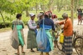 6th April, 2022, Dhupjhora, West Bengal, India: An old man serving dinking water to the female tea garden labours near the