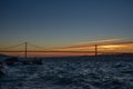 The 25th of April suspension bridge over the Tagus river, at sunset, in Lisbon, Portugal Royalty Free Stock Photo