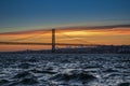 The 25th of April suspension bridge over the Tagus river, at sunset, in Lisbon, Portugal Royalty Free Stock Photo