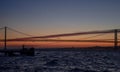 The 25th of April suspension bridge over the Tagus river, at sunset, in Lisbon, Portugal Royalty Free Stock Photo