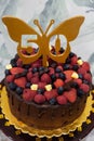 50th birthday cake with chocolate, strawberries and blueberries Royalty Free Stock Photo