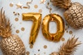 70th birthday celebration card with gold foil balloons and golden pineapples