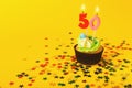 50th birthday cupcake with candle and sprinkles Royalty Free Stock Photo